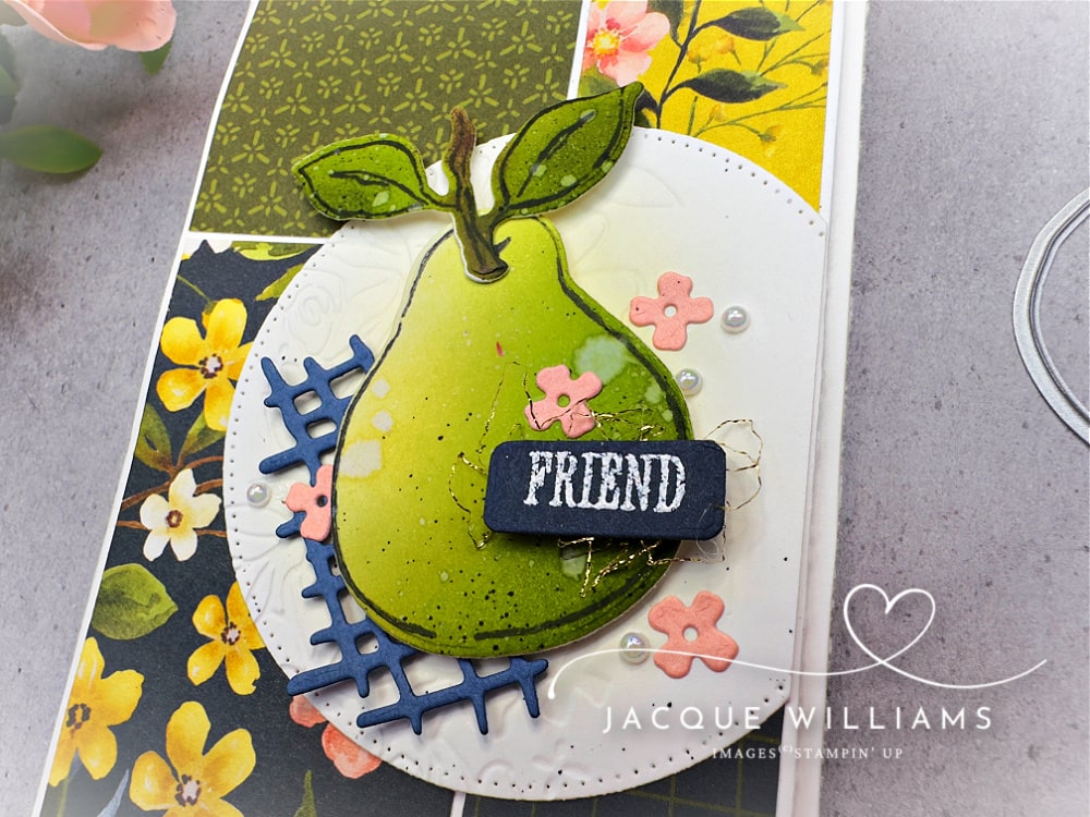 Handmade slimline friendship card featuring the Painterly Pears designer papers in rich green, yellow, and navy floral prints. The focal point is a stamped and die-cut pear from the Perfect Pears bundle, colored with a quick ink blending technique, layered on a stitched white circle with a navy die-cut accent. Finished with the word “Friend” in white embossing on navy cardstock. Card layout follows Sketch #20 from the Design Spark sketch book.